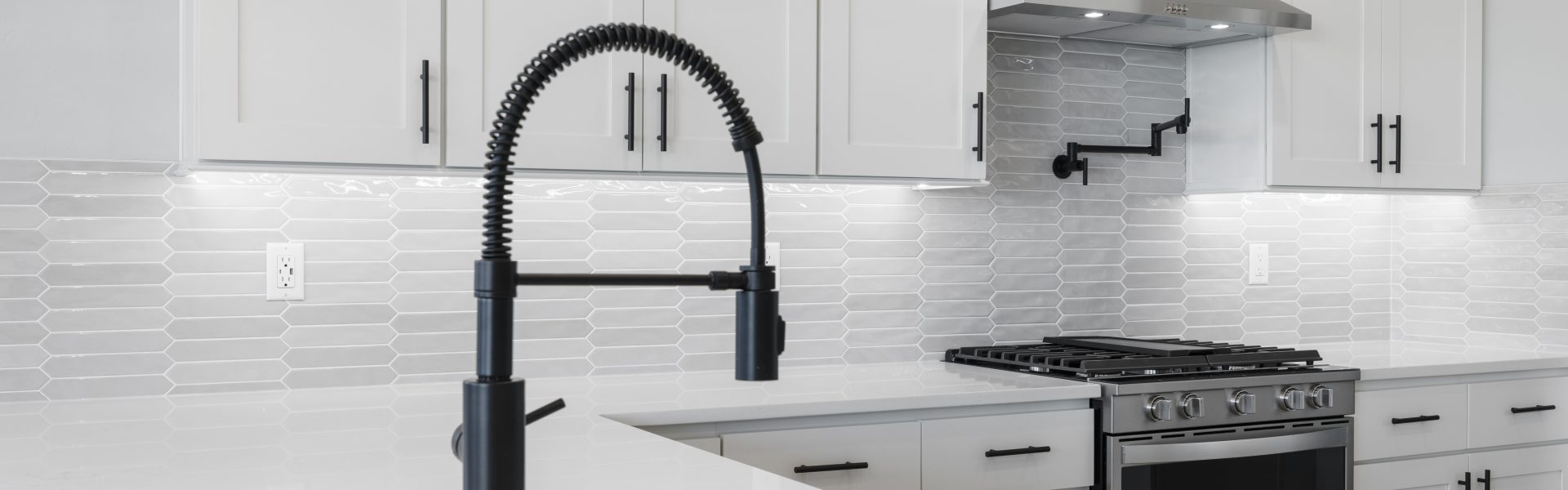 up close image of a matte black kitchen sink hardware piece