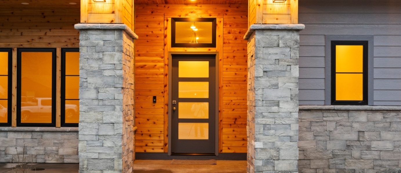 Front entry of a modern prairie home at dusk