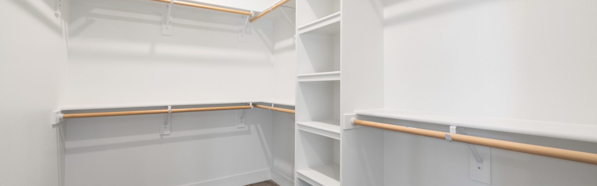 Walk in closet with white built in shelving