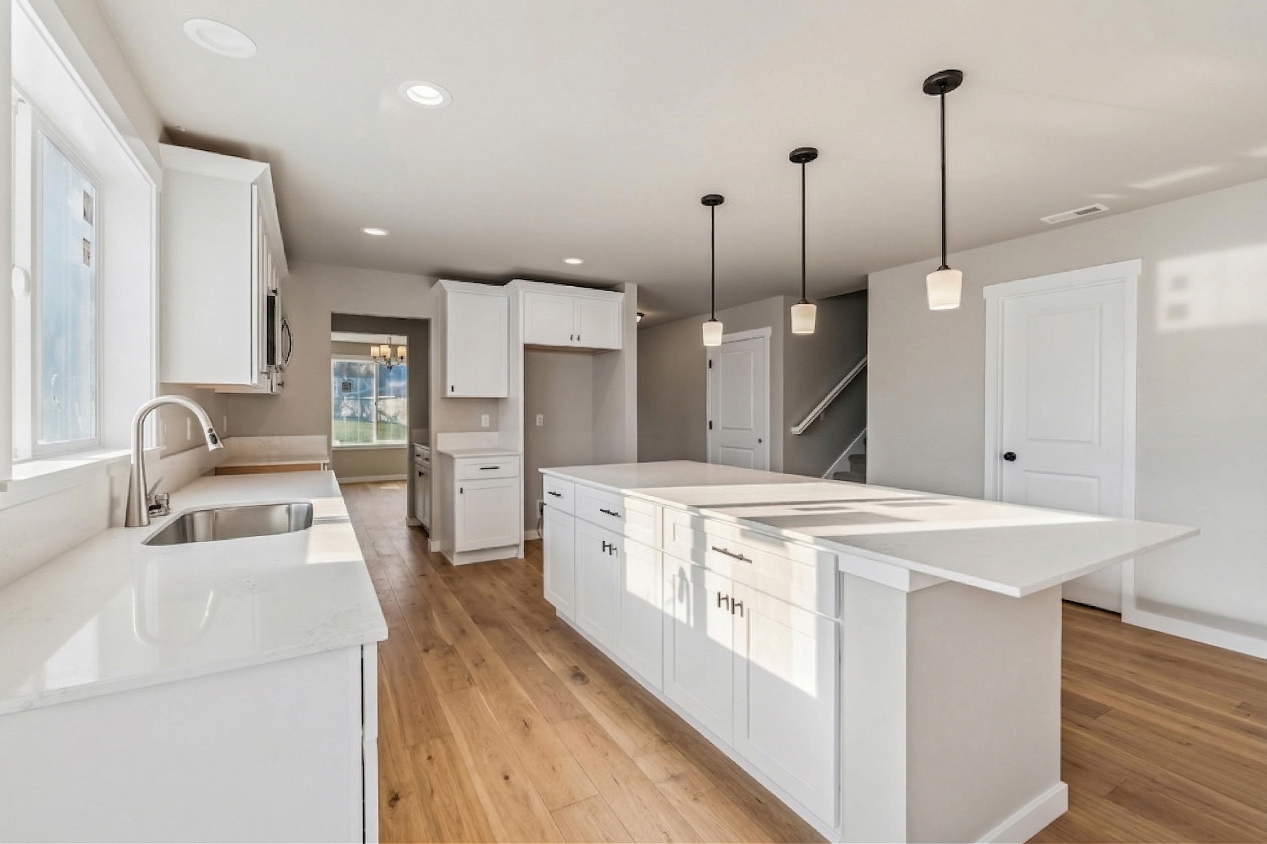 founders Collection kitchen — bright open kitchen with quartz countertops and white cabinetry