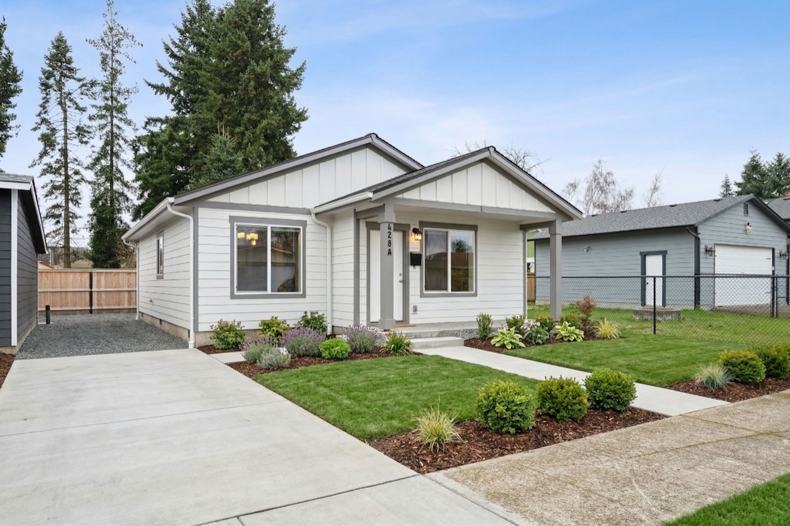 founders Collection home exterior — white craftsman home with landscaped front yard